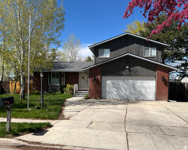 2163 Borg Drive Sandy, UT 84092 - Photo 27 of 31 View of front facade with brick siding and driveway