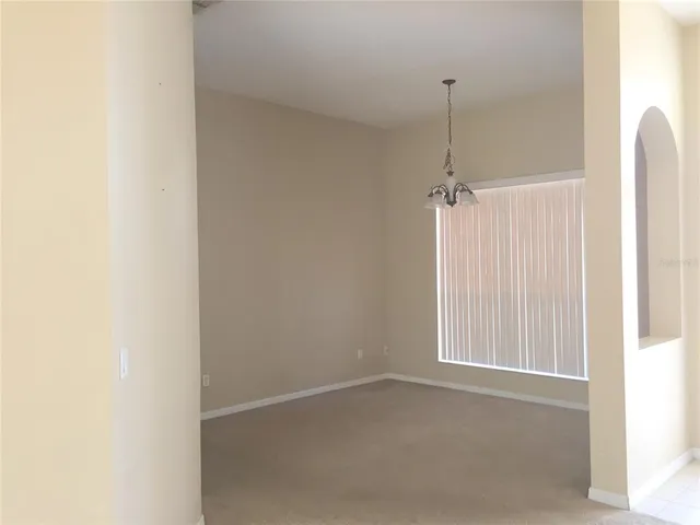 a view of a room with a ceiling fan