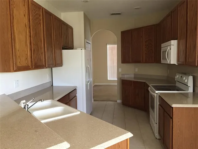 a kitchen with a sink a stove and refrigerator