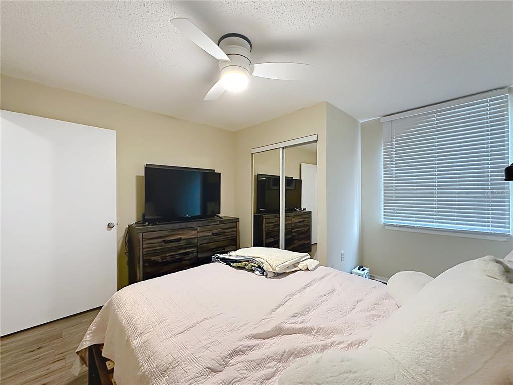 3705 Southwest 27th Street, Unit 922 Gainesville, FL 32608 - Photo 25 of 34 a bedroom with a bed and a flat screen tv
