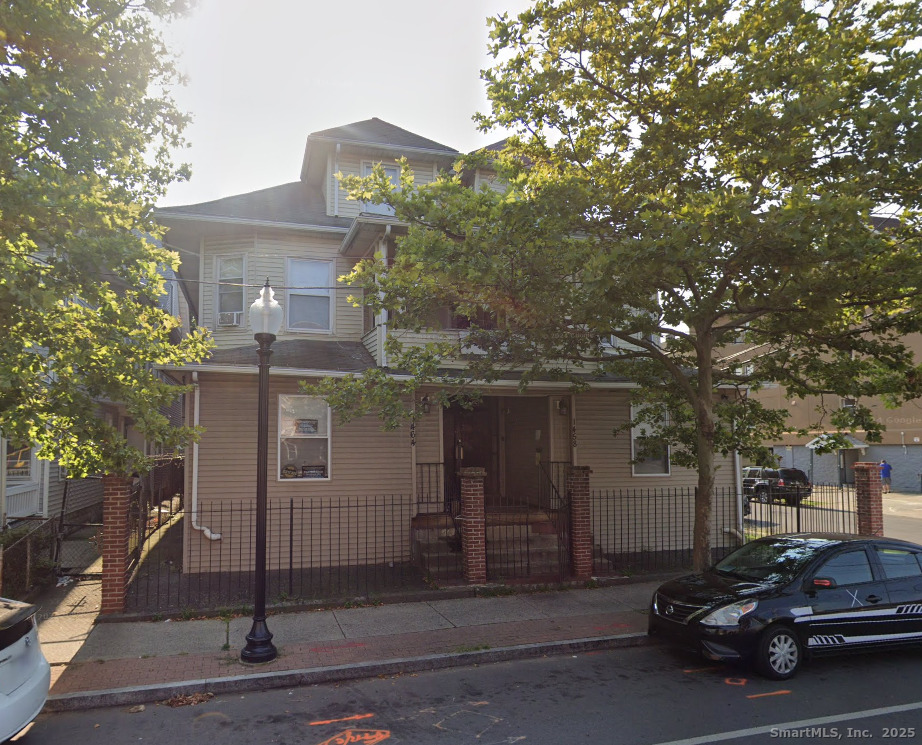 1458 East Main Street, Unit 2 Bridgeport, CT 06608 - Photo 1 of 6 a view of a car park in front of house