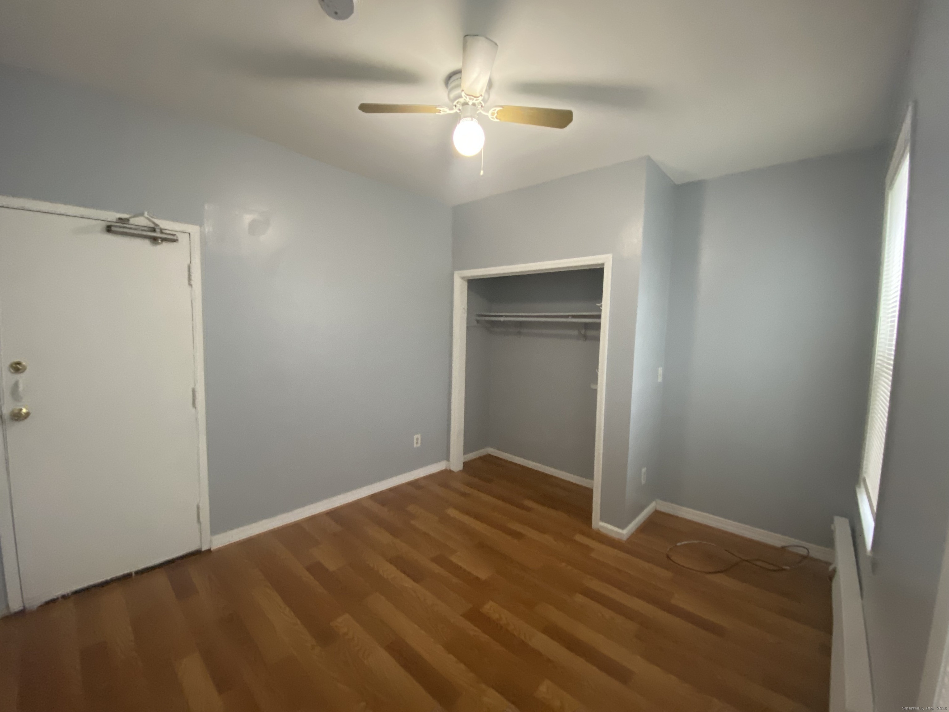 1458 East Main Street, Unit 2 Bridgeport, CT 06608 - Photo 2 of 6 a view of a room with a ceiling fan and a hardwood