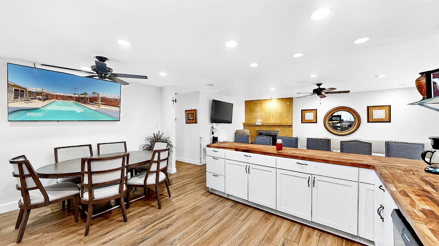 2720 Brooks Court Turlock, CA 95382 - Photo 15 of 50 a kitchen with a dining table chairs and white cabinets