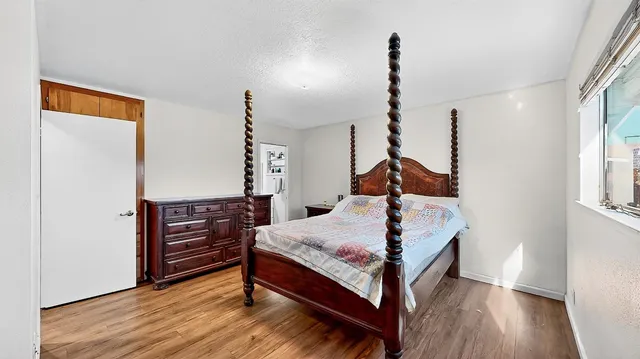 a bed room with a bed and a window