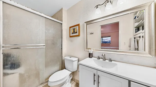 a bathroom with a sink toilet and shower