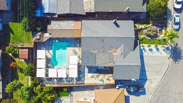 an aerial view of residential houses with outdoor space