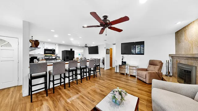 a living room with furniture kitchen view and a fireplace