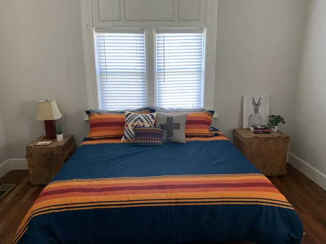 a bedroom with a bed and window