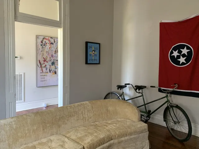 a bedroom with a bed and a lamp on the table