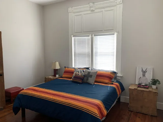 a bedroom with a bed and window
