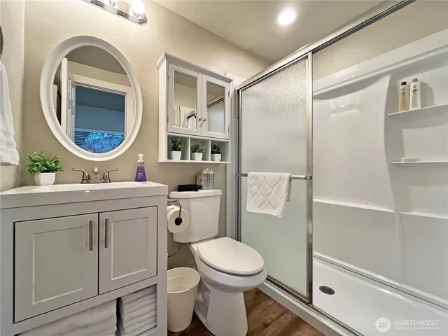 a view of a house with a small yard and a large tree