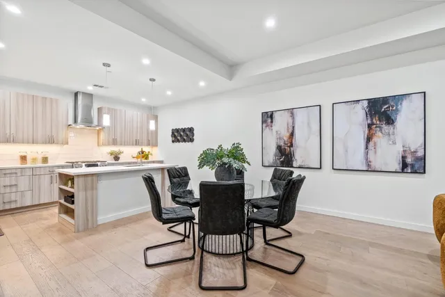 a view of kitchen with granite countertop cabinets table and chairs
