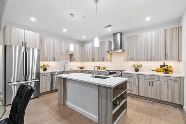 a kitchen with a sink stove and refrigerator