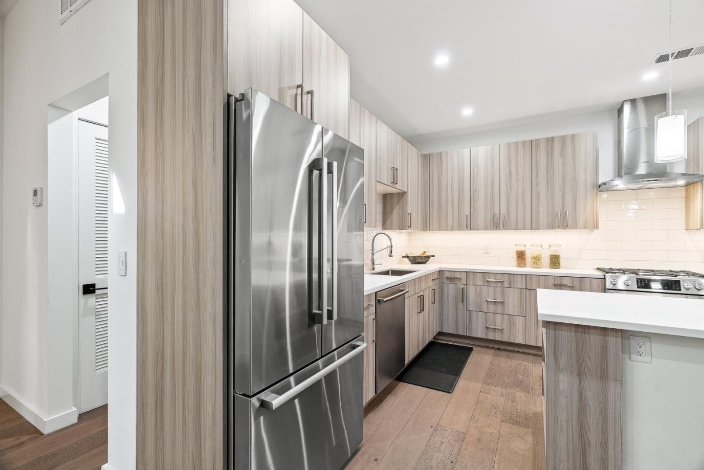 908 Woodside Road Redwood City, CA 94061 - Photo 16 of 34 a kitchen with granite countertop a refrigerator and a sink