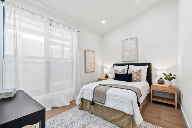 a bedroom with a bed and a window