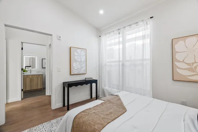 a bedroom with a bed and a chandelier