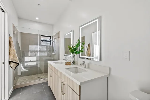 a bathroom with a sink a mirror and a shower