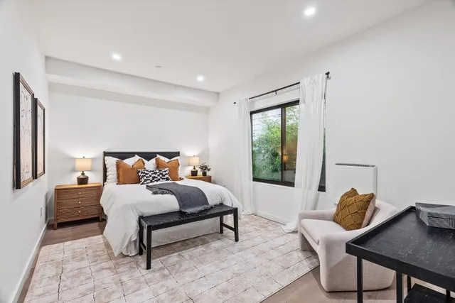 a bedroom with a bed and a window