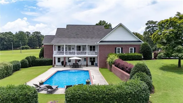 a view of a dining room with furniture a chandelier and wooden floor