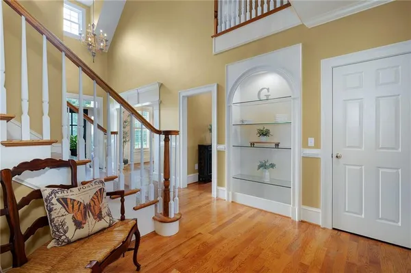 a view of a hallway with wooden floor and stairs