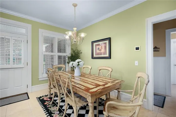 a spacious bedroom with a bed and a chandelier