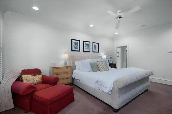 a front view of a house with garden and a patio