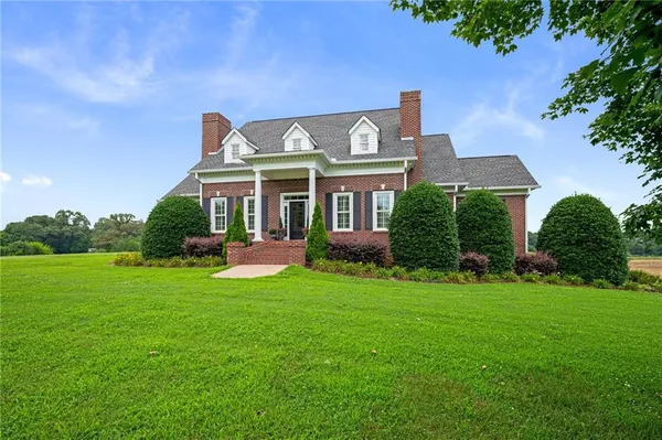 a view of a house with a yard porch and sitting area