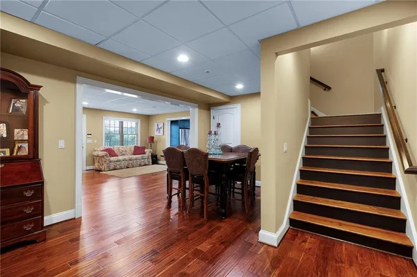 a view of a house with a big yard potted plants and large tree