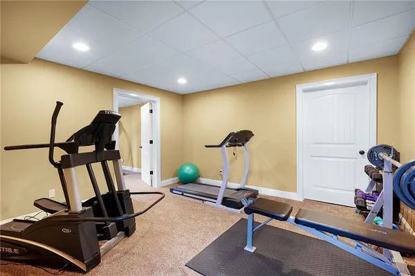 a kitchen with stainless steel appliances granite countertop a stove a sink dishwasher oven a dining table and chairs with wooden cabinets