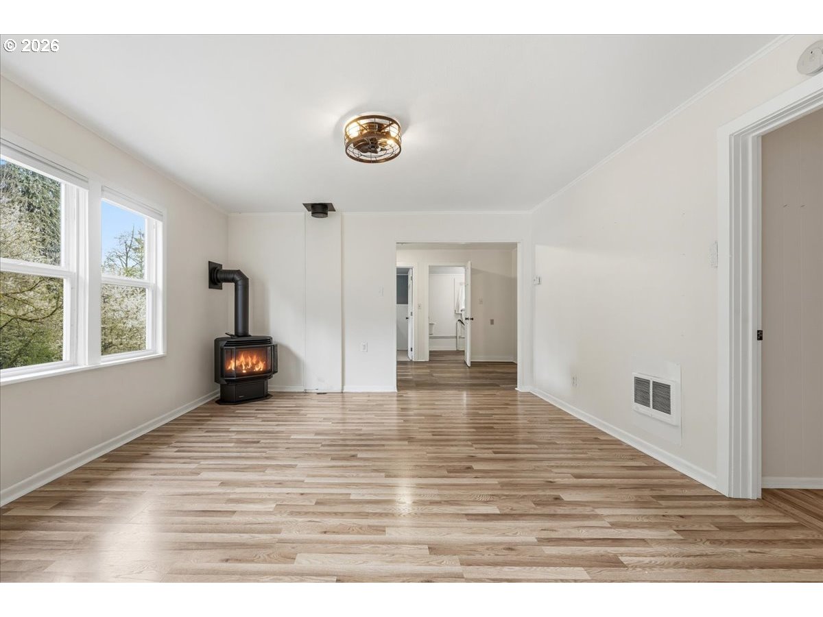 51 Wilkinson Street Carson, WA 98610 - Photo 13 of 37 a view of an empty room with wooden floor and a window