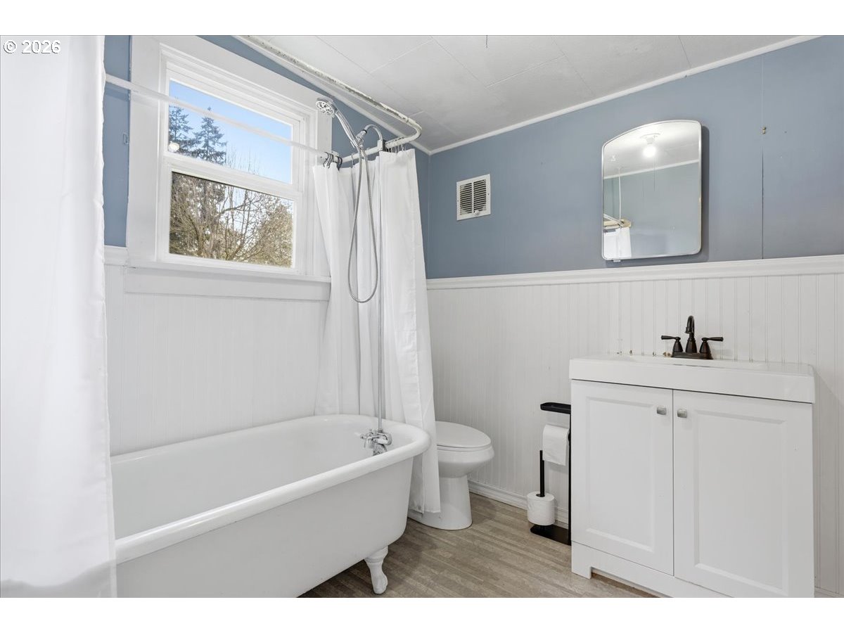 51 Wilkinson Street Carson, WA 98610 - Photo 21 of 37 a bathroom with a sink a mirror a toilet and a bathtub