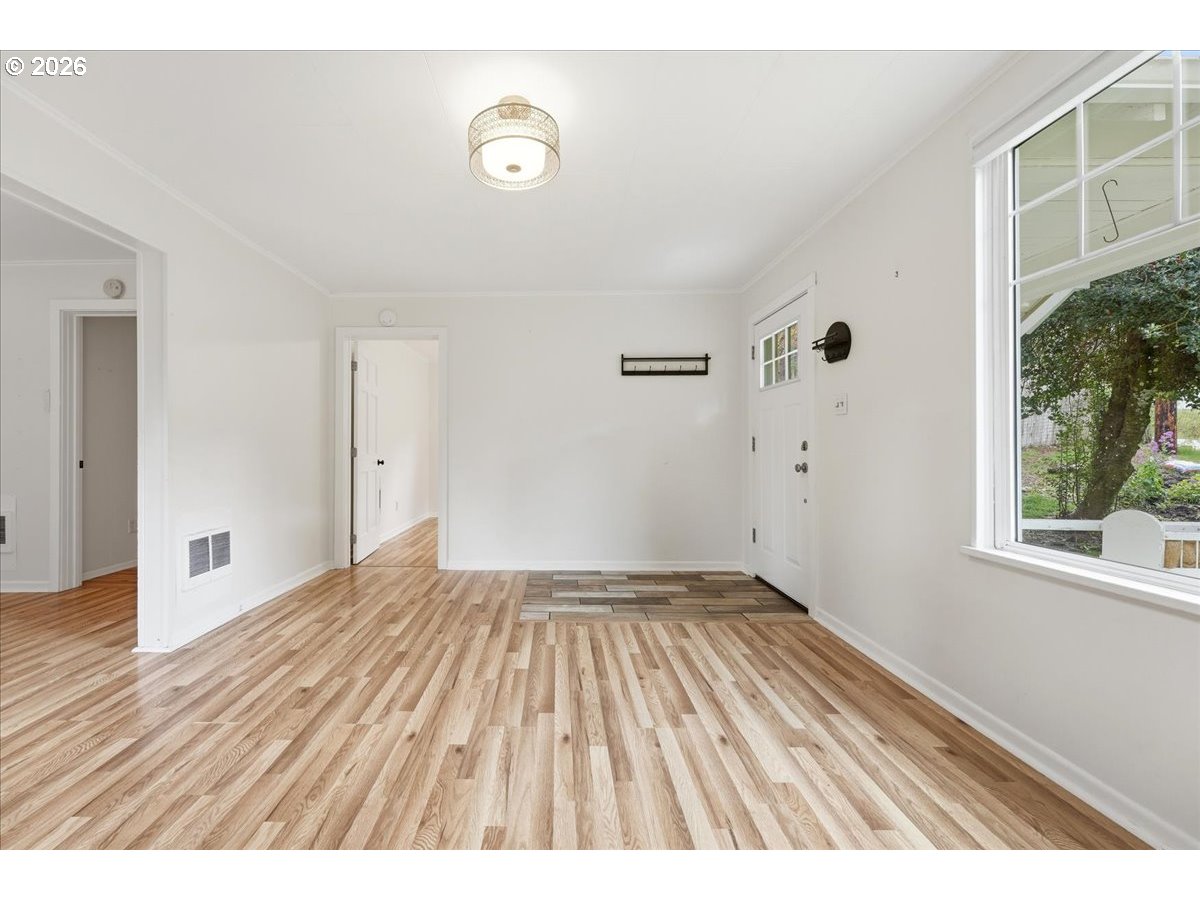 51 Wilkinson Street Carson, WA 98610 - Photo 25 of 37 a view of an empty room with wooden floor and a window