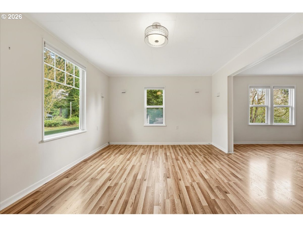 51 Wilkinson Street Carson, WA 98610 - Photo 26 of 37 an empty room with wooden floor and windows