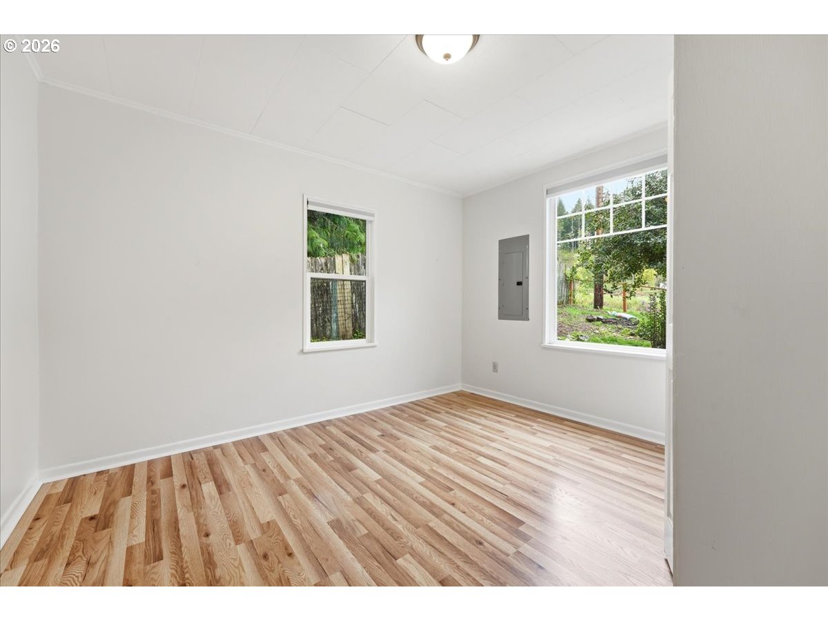 51 Wilkinson Street Carson, WA 98610 - Photo 30 of 37 an empty room with wooden floor and windows