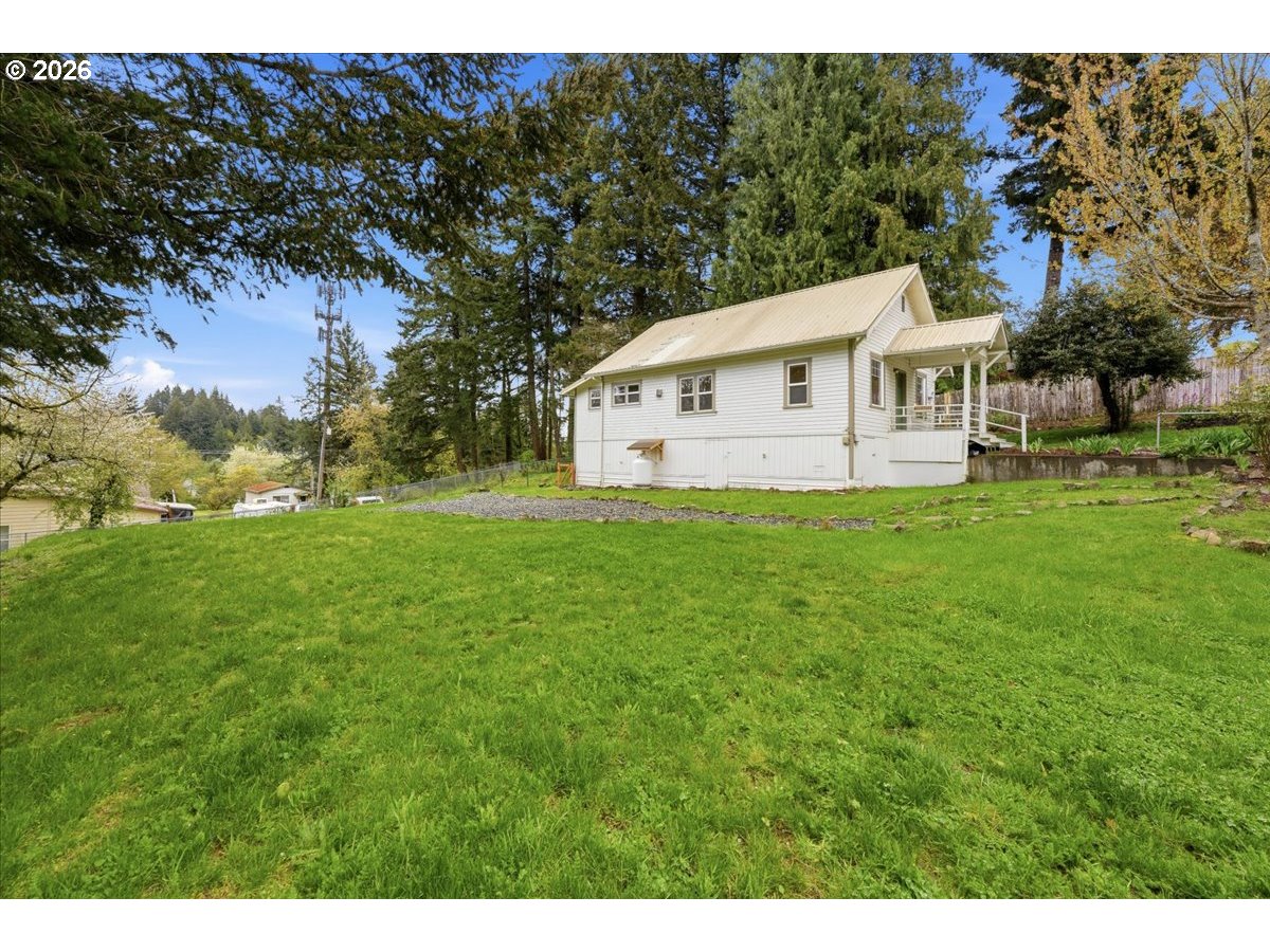 51 Wilkinson Street Carson, WA 98610 - Photo 3 of 37 a view of a house with a big yard and large trees