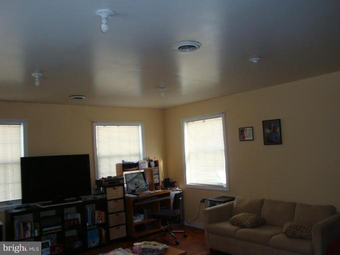 2713 Terrapin Road Silver Spring, MD 20906 - Photo 4 of 10 a living room with furniture and a flat screen tv