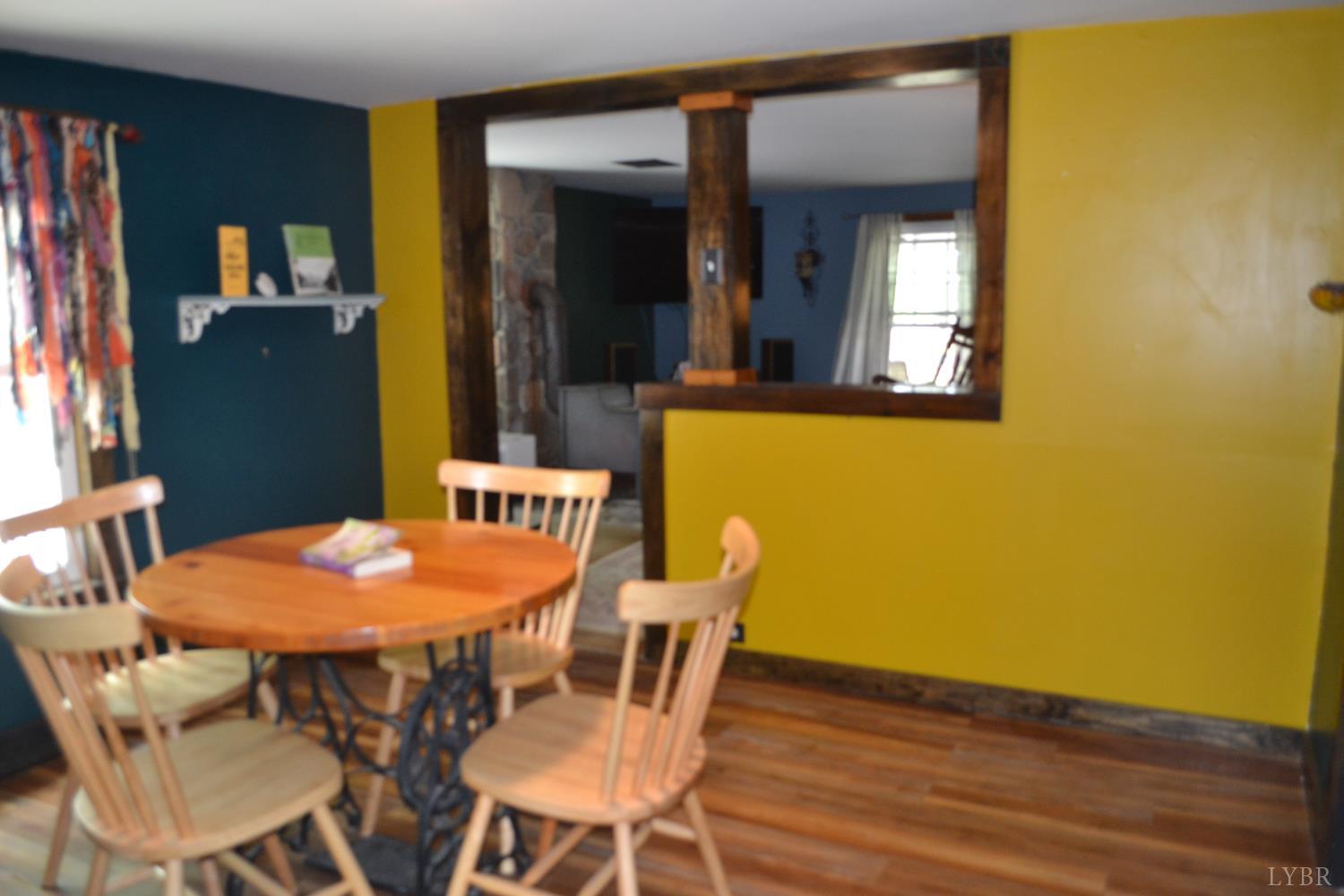 6387 Red House Road Rustburg, VA 24588 - Photo 23 of 38 a view of a dining room with furniture and wooden floor