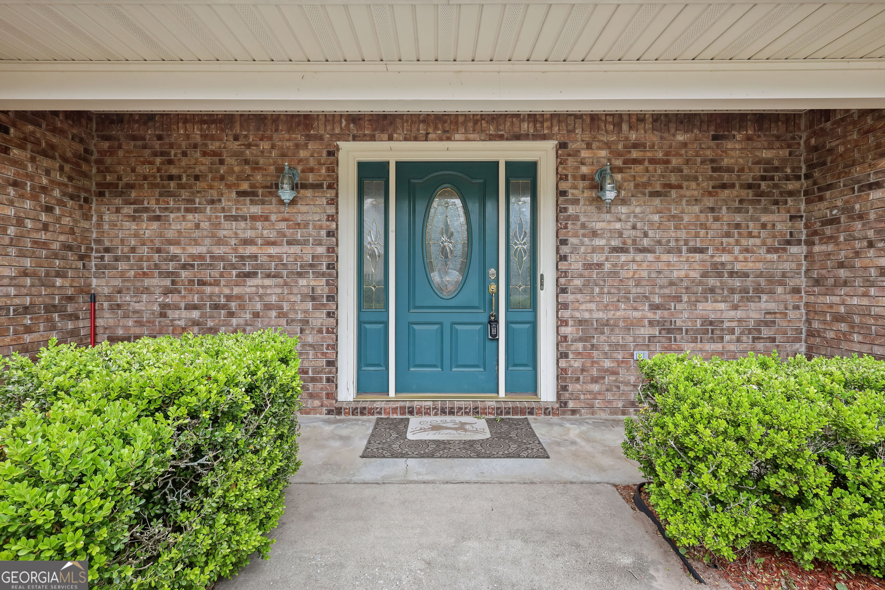 103 Cartwright Circle Brunswick, GA 31525 - Photo 2 of 54 a front view of a house with a garden
