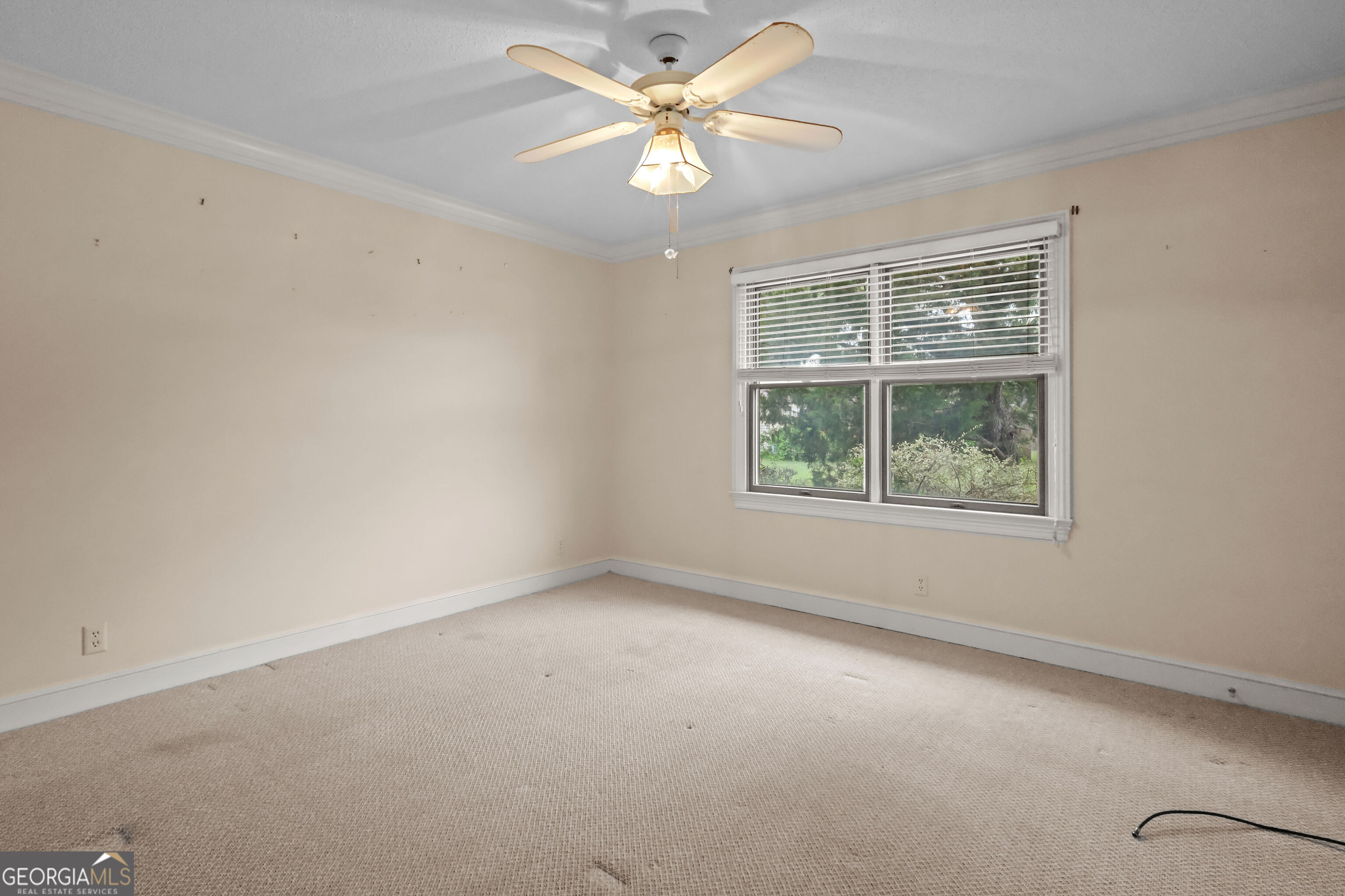 103 Cartwright Circle Brunswick, GA 31525 - Photo 24 of 54 an empty room with a window and a fan
