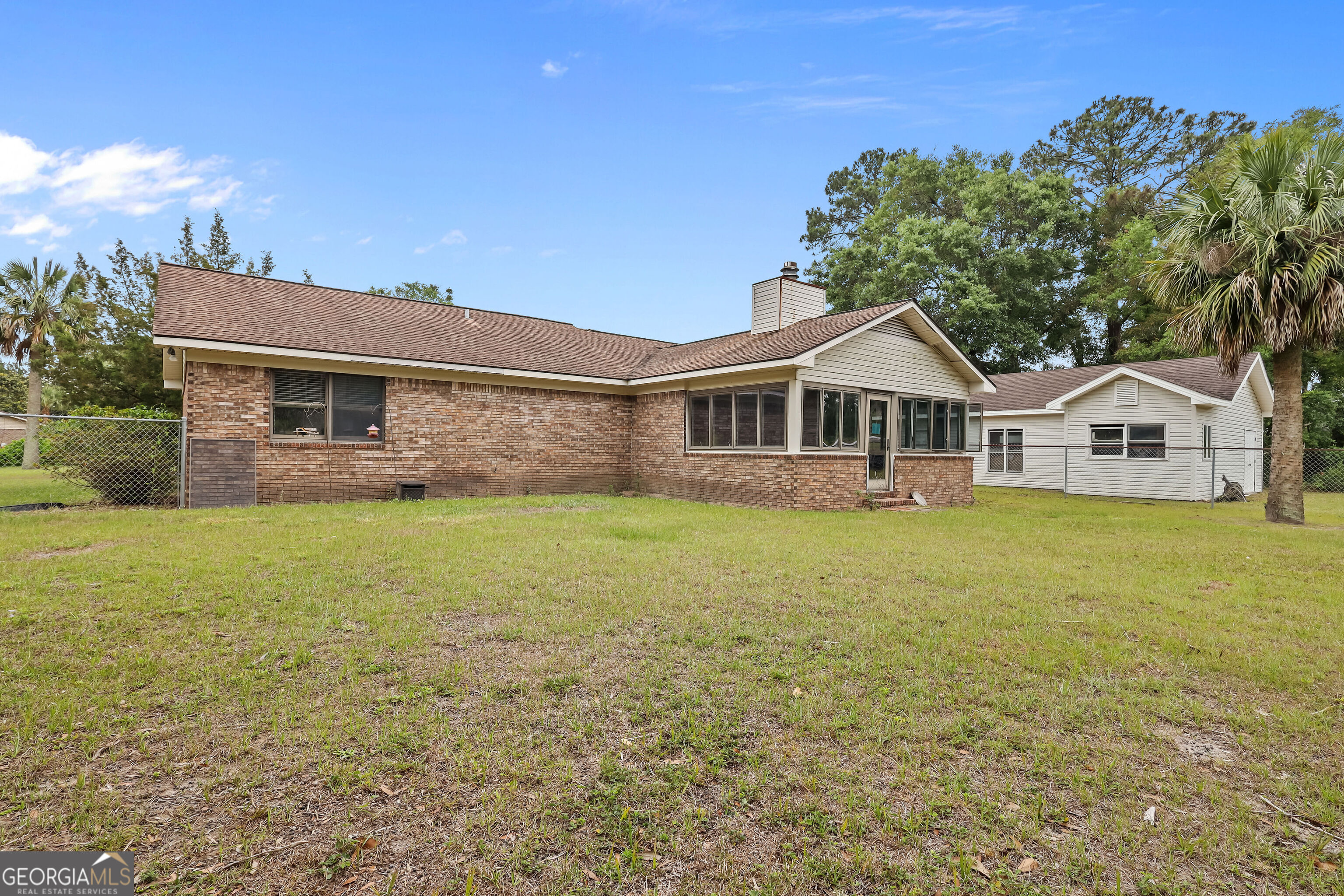 103 Cartwright Circle Brunswick, GA 31525 - Photo 32 of 54 a front view of a house with garden