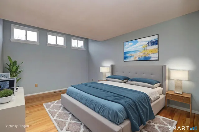 a bedroom with a bed and a potted plant