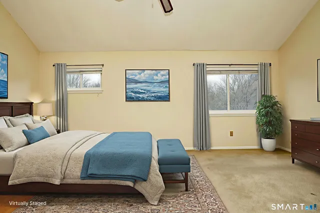 a bedroom with a bed and a painting on the wall