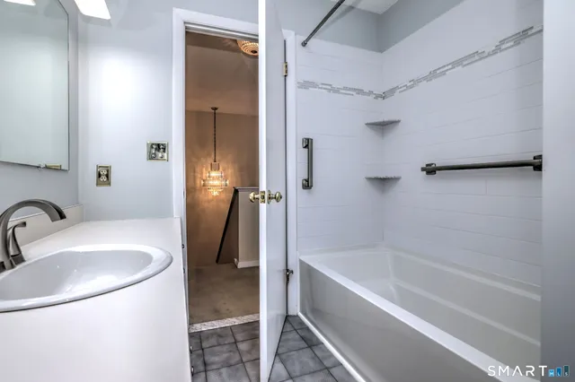 a bathroom with a sink a mirror and a bathtub