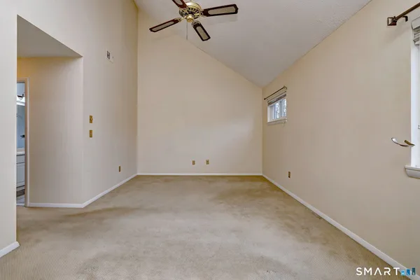 a view of a room with a chandelier fan and closet