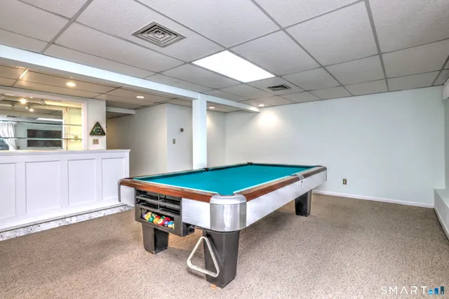 a room with furniture and pool table