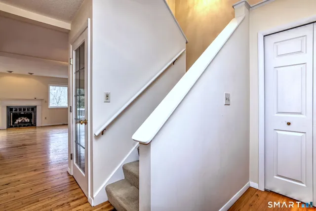 a view of entryway and hall with wooden floor
