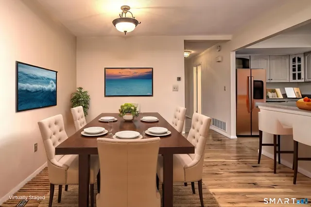 a view of a dining room with furniture and wooden floor