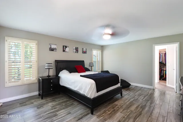 a bedroom with a bed and a large window