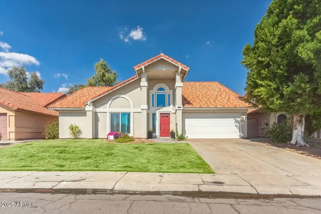 a front view of a house with a yard and garage