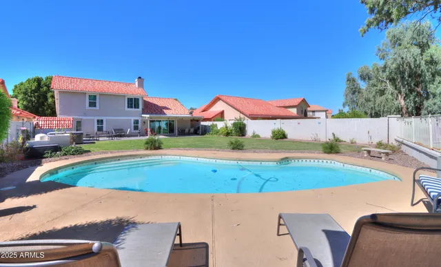 a view of an house with backyard space and balcony